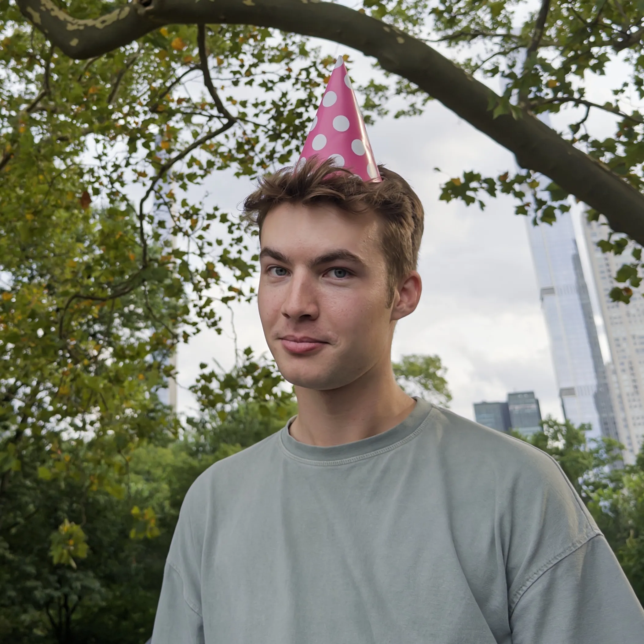 Henry wearing a pink polka-dot party hat in Central Park