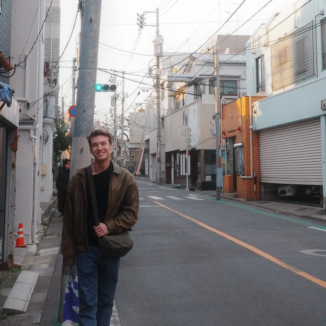 Henry smiling on a quiet street in Tokyo